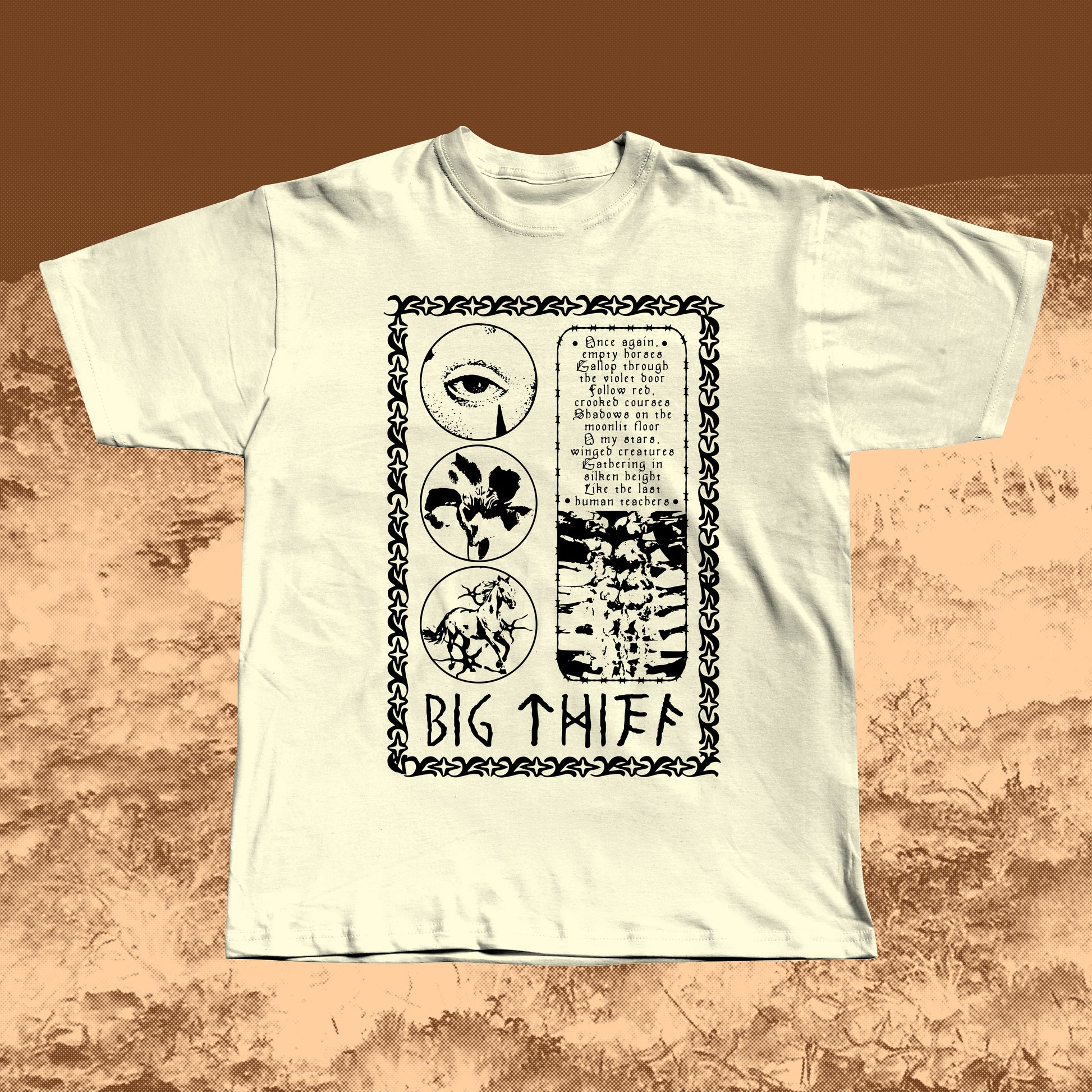 Beige T-shirt with black vintage-style print featuring an eye, flower, skeleton ribcage, and a poetic text block framed by a decorative border with “BIG THIEF” written at the bottom.