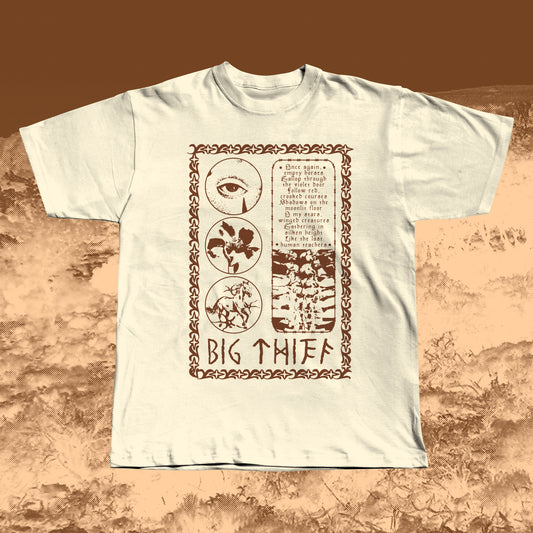 Beige T-shirt with earthy brown vintage-style print featuring an eye, flower, skeleton ribcage, and a poetic text block framed by a decorative border with “BIG THIEF” written at the bottom.