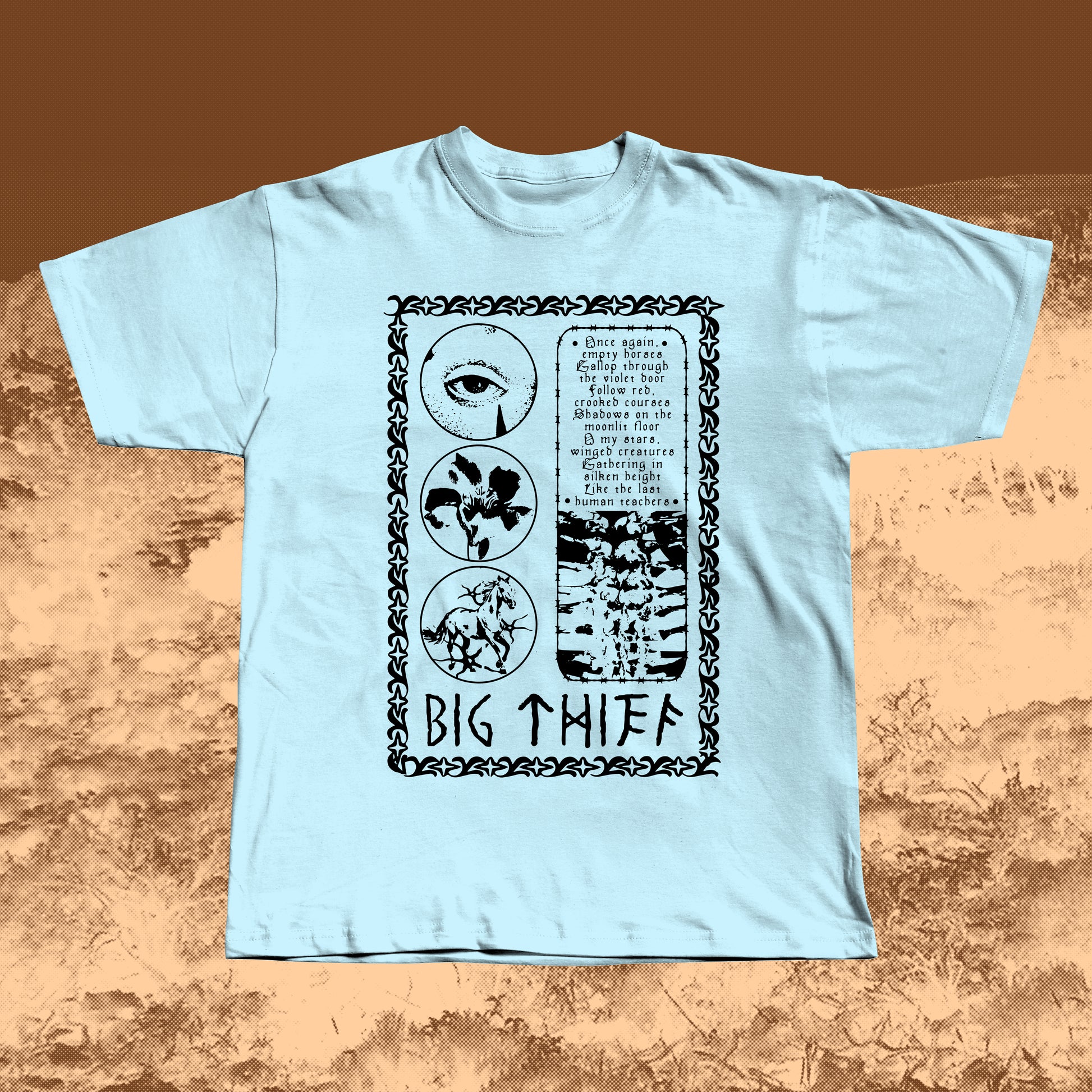 Light Blue T-shirt with black vintage-style print featuring an eye, flower, skeleton ribcage, and a poetic text block framed by a decorative border with “BIG THIEF” written at the bottom.