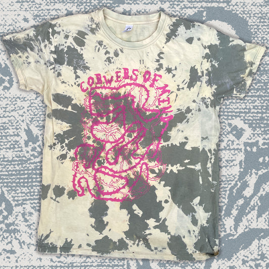 Bleached t-shirt with pink graphic design on a textured surface