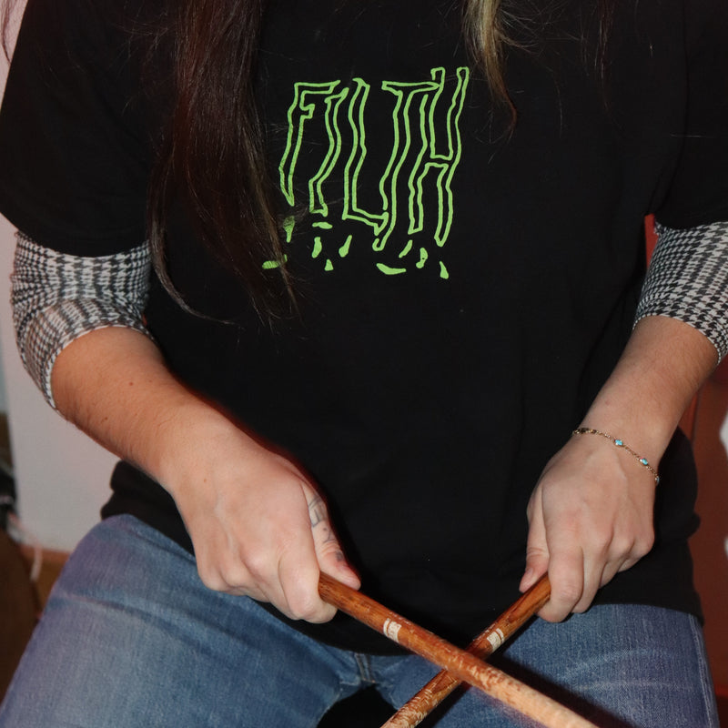 Person playing drums with a close-up of hands and drumsticks.