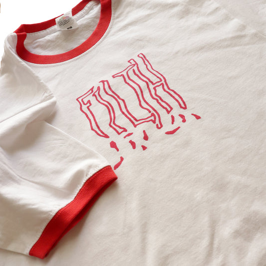 Close-up view of white and red ringer t-shirt with the word FILTH printed on it.