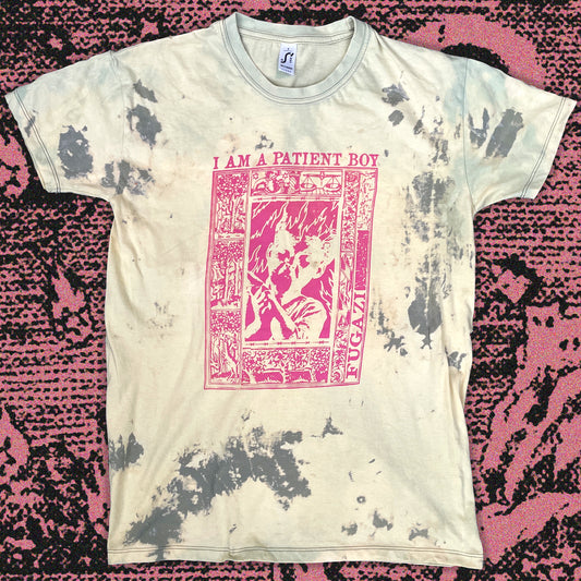Bleached tie-dye T-shirt in soft cream with scattered gray distress patterns, hand screen printed in bright pink ink with a bold graphic design inspired by Fugazi.Each shirt has unique bleach markings for a one-of-a-kind, grunge look.