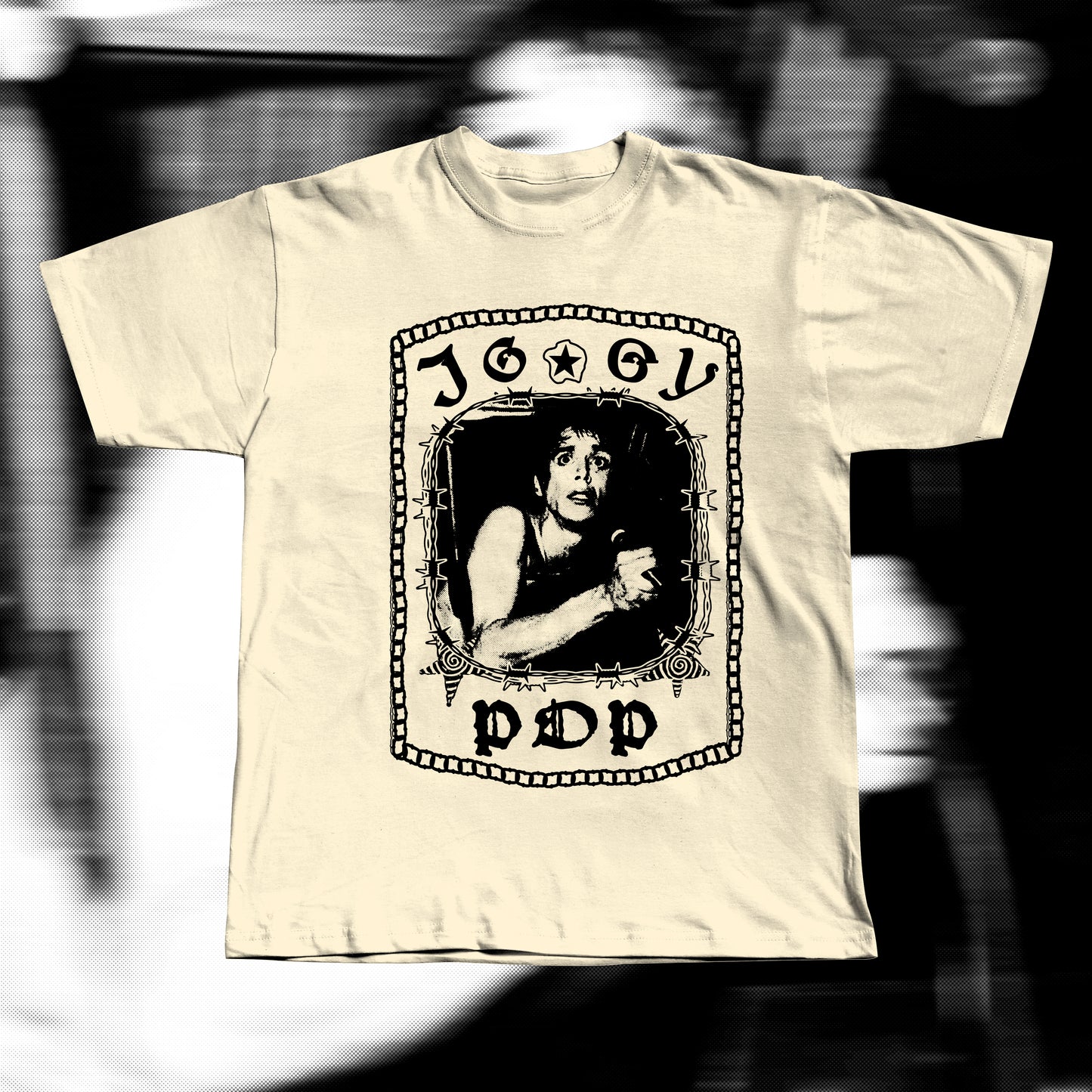 Unisex adult beige t-shirt, design with iggy pop tangled in a chair around barbed wire. Iggy pop is written around with gothic letters.