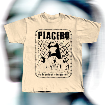 Handmade beige t-shirt featuring purple screen-printed fan art inspired by Placebo. The design shows the band members in front of a chain-link fence with “PLACEBO” written in bold distressed letters and the lyric “baby did you forget to take your meds?” below, surrounded by a barbed-wire border.