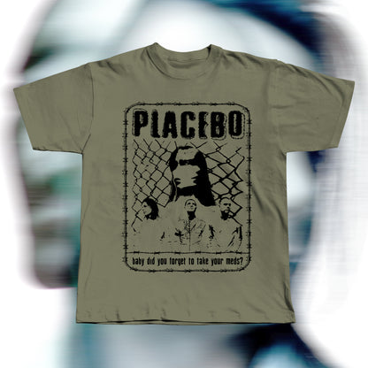 Handmade khaki t-shirt featuring purple screen-printed fan art inspired by Placebo. The design shows the band members in front of a chain-link fence with “PLACEBO” written in bold distressed letters and the lyric “baby did you forget to take your meds?” below, surrounded by a barbed-wire border.