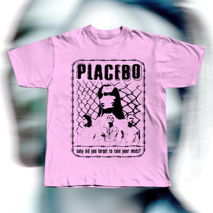 Handmade pink t-shirt featuring purple screen-printed fan art inspired by Placebo. The design shows the band members in front of a chain-link fence with “PLACEBO” written in bold distressed letters and the lyric “baby did you forget to take your meds?” below, surrounded by a barbed-wire border.