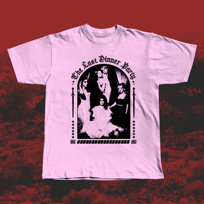 Pink handmade screen-printed T-shirt featuring a black The Last Dinner Party-inspired design with the band in dramatic poses framed by gothic arches and decorative elements.